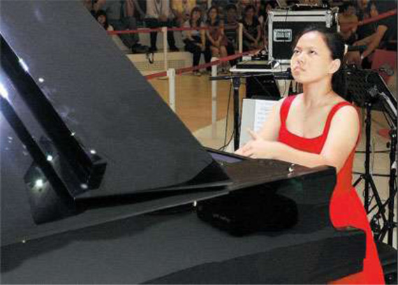 Zhang Ruixue, 15, performs on a specially designed grand piano with four pedals, after she beat 17 fellow contestants in a piano competition at the World Expo yesterday. Zhang, a Beijing native, won 12,000 yuan (US$1,765) and a four-pedal piano for her school.